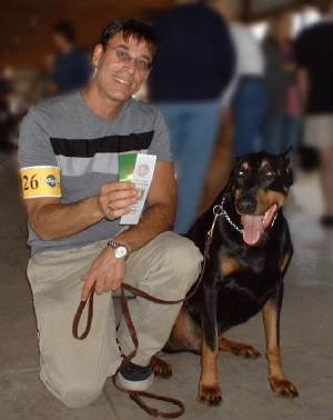 Marc and rescued Doberman Diablo finishing their American Kennel Club CD title in the money.